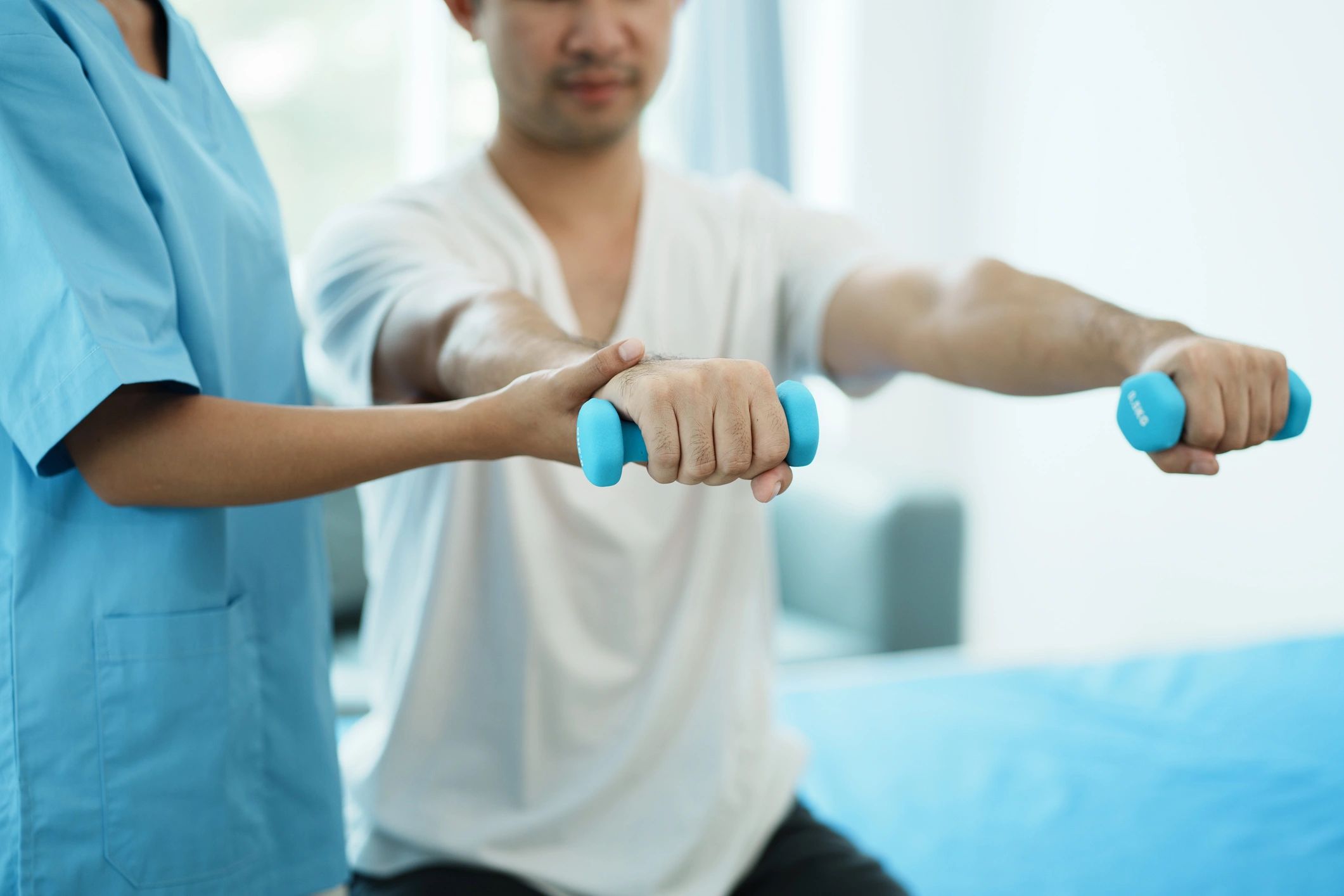 Physiotherapist treating rehabilitation arm pain patient doing physical